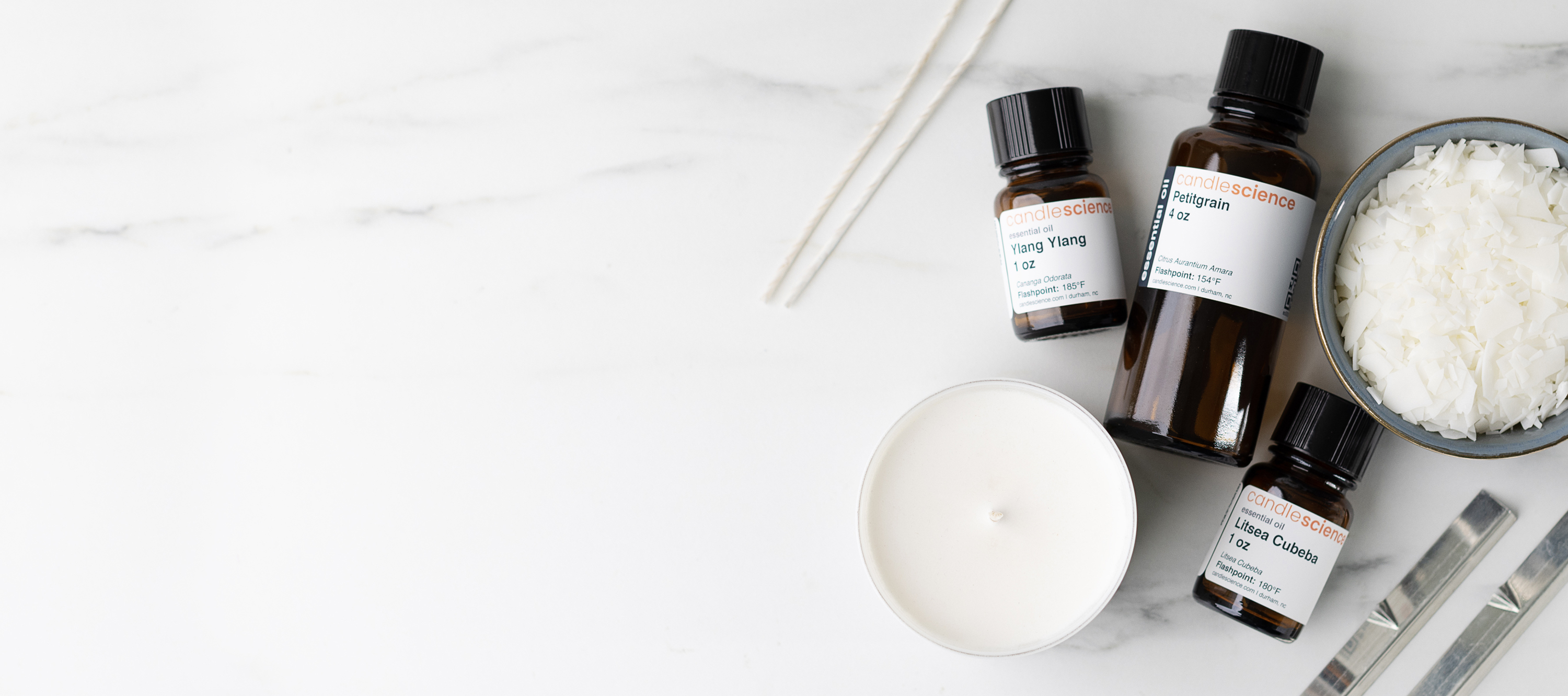 Essential oils, wax, wicks, candle, and wick bars.