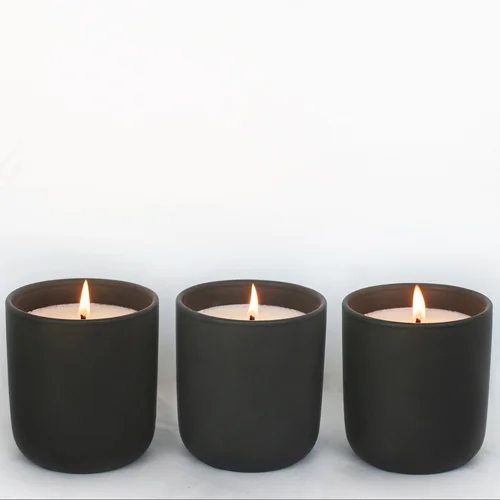 Black Tumbler Candle on table.